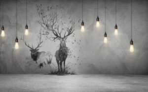 Modern monochrome wallpaper mural featuring two majestic deer, including a tree-antler stag, on a textured concrete background with hanging Edison lights for a contemporary industrial look.