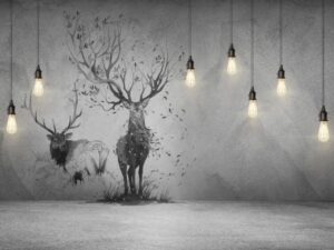 Modern monochrome wallpaper mural featuring two majestic deer, including a tree-antler stag, on a textured concrete background with hanging Edison lights for a contemporary industrial look.
