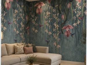 Teal tropical floral wallpaper mural with cascading pink blossoms, hummingbirds, and lush foliage in a modern living room.