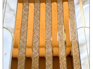 golden decorative fluted wall panel with textured geometric strips