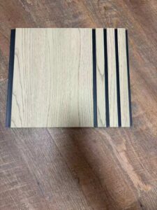 Cream white wood-texture fluted wall panel with vertical grooves and a minimalist design