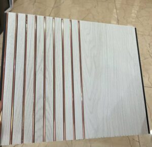 White marble finish fluted wall panel with rose gold vertical lines