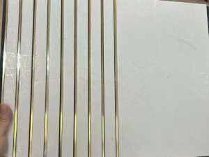 White marble finish fluted panel with elegant golden strips