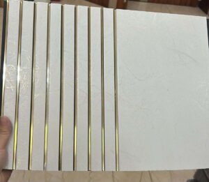 White marble finish fluted panel with elegant golden strips