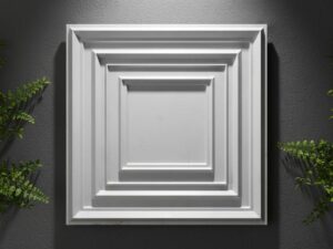 White 3D decorative wall panel with layered rectangular geometric borders mounted on a dark textured wall.