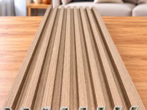 Beige wood-grain slatted wall panel displayed on a wooden table in a modern living room.